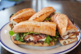 BAGUETTE SANDWICHES WITH PROSCIUTTO, BRIE, CARAMELIZED ONIONS FENNEL AND OLIVE TAPENADE