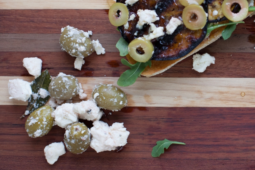 GRILLED EGGPLANT TARTINES WITH ARUGULA, FETA, GREEN OLIVES AND HONEY