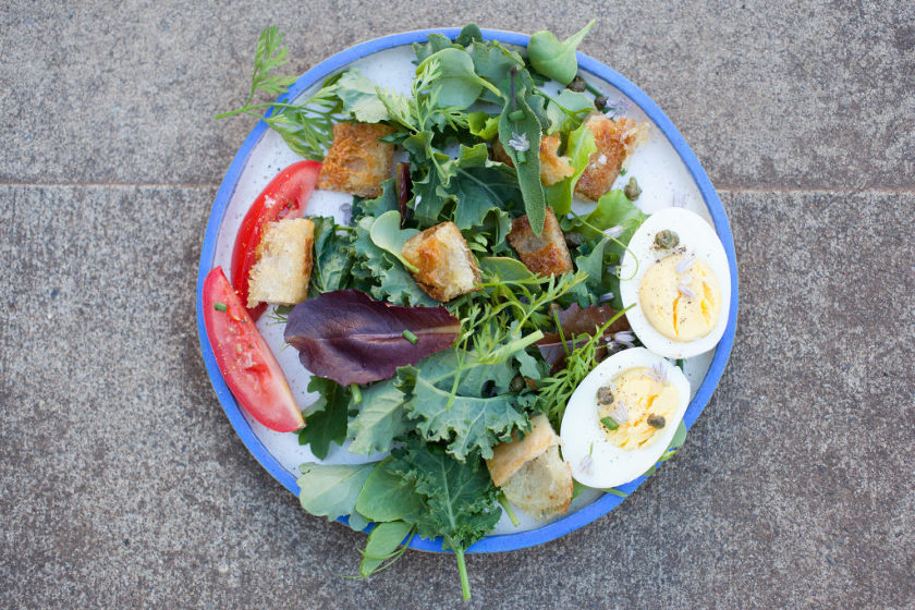 SALAD WITH HARD BOILED EGGS, GARLIC CROUTONS, FRIED CAPERS, AND BREADCRUMB DRESSING